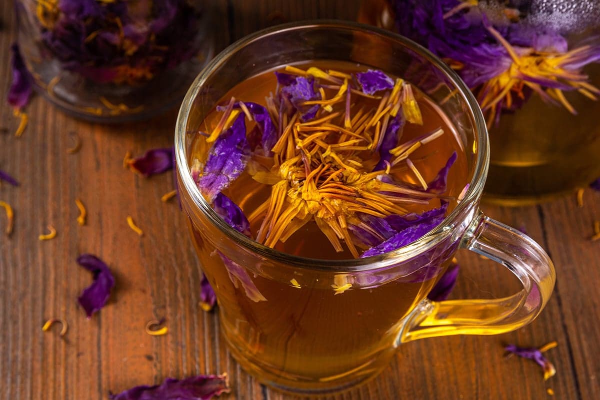 Blue Lotus Tea in cup on wood table